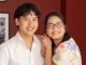 A woman and a man smiling at the camera